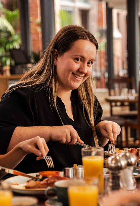 Woman Eating At A Dinner Table In The Oakfield